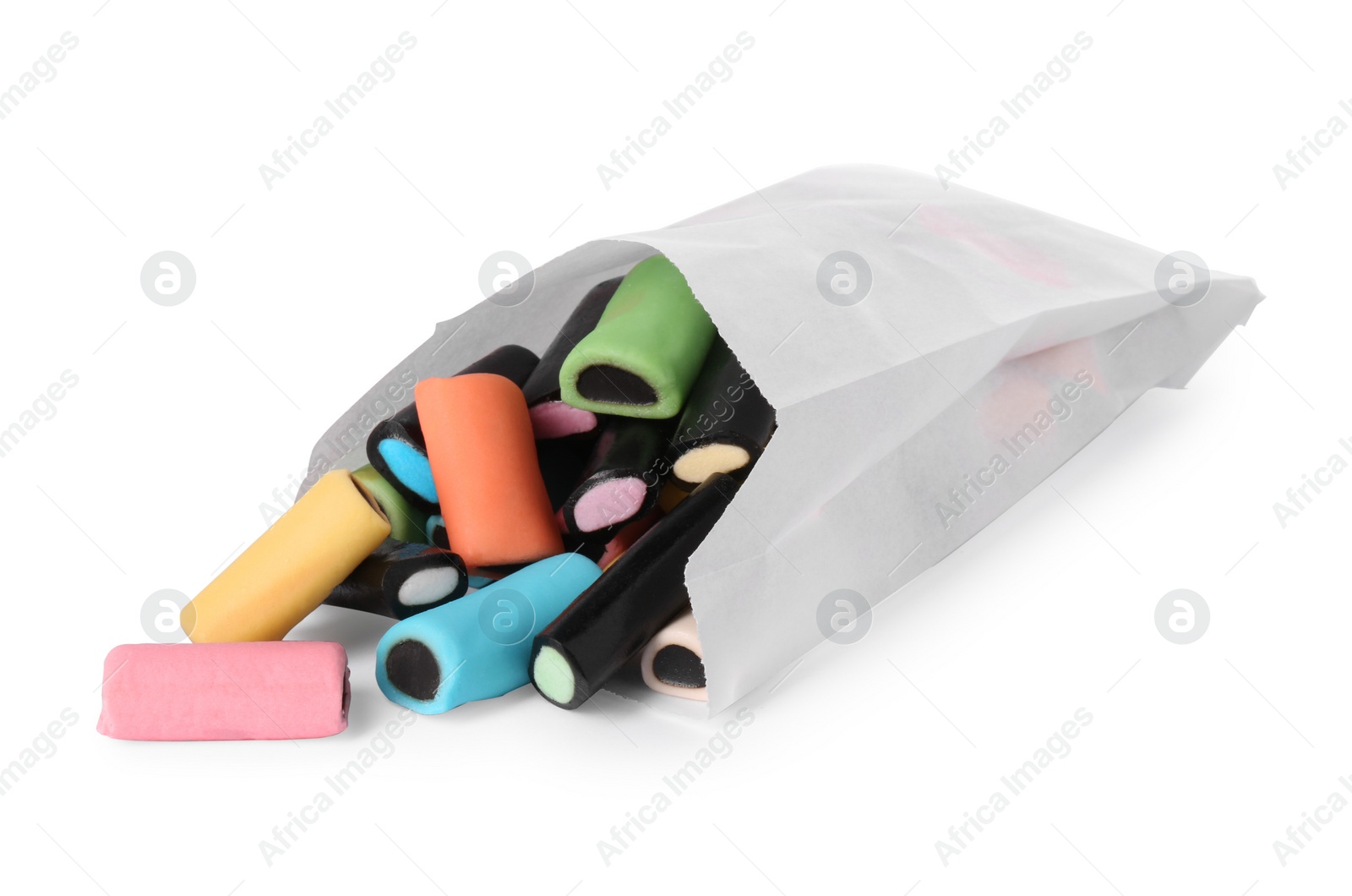 Photo of Paper bag with tasty liquorice candies isolated on white