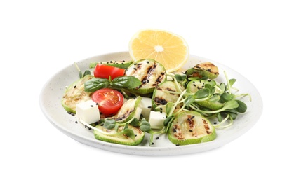 Photo of Delicious grilled zucchini slices served with feta cheese, tomatoes and lemon on white background