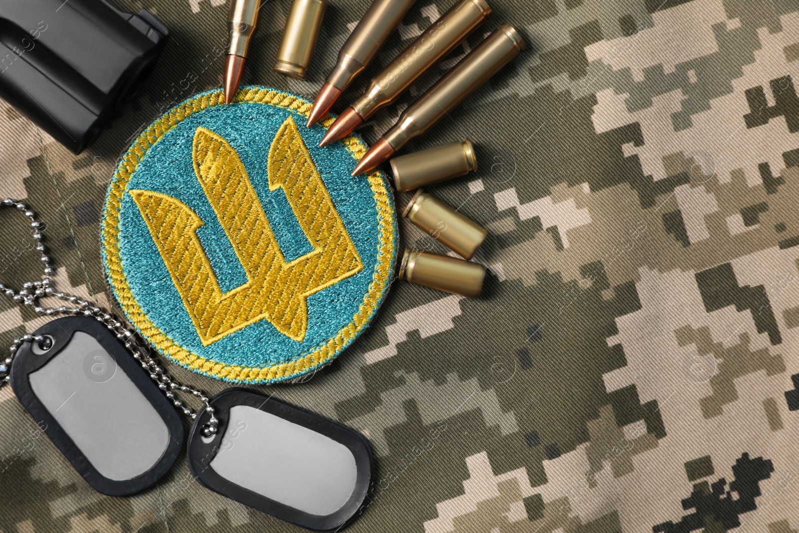 Photo of MYKOLAIV, UKRAINE - SEPTEMBER 19, 2020: Flat lay composition with Ukraine military equipment on camouflage background