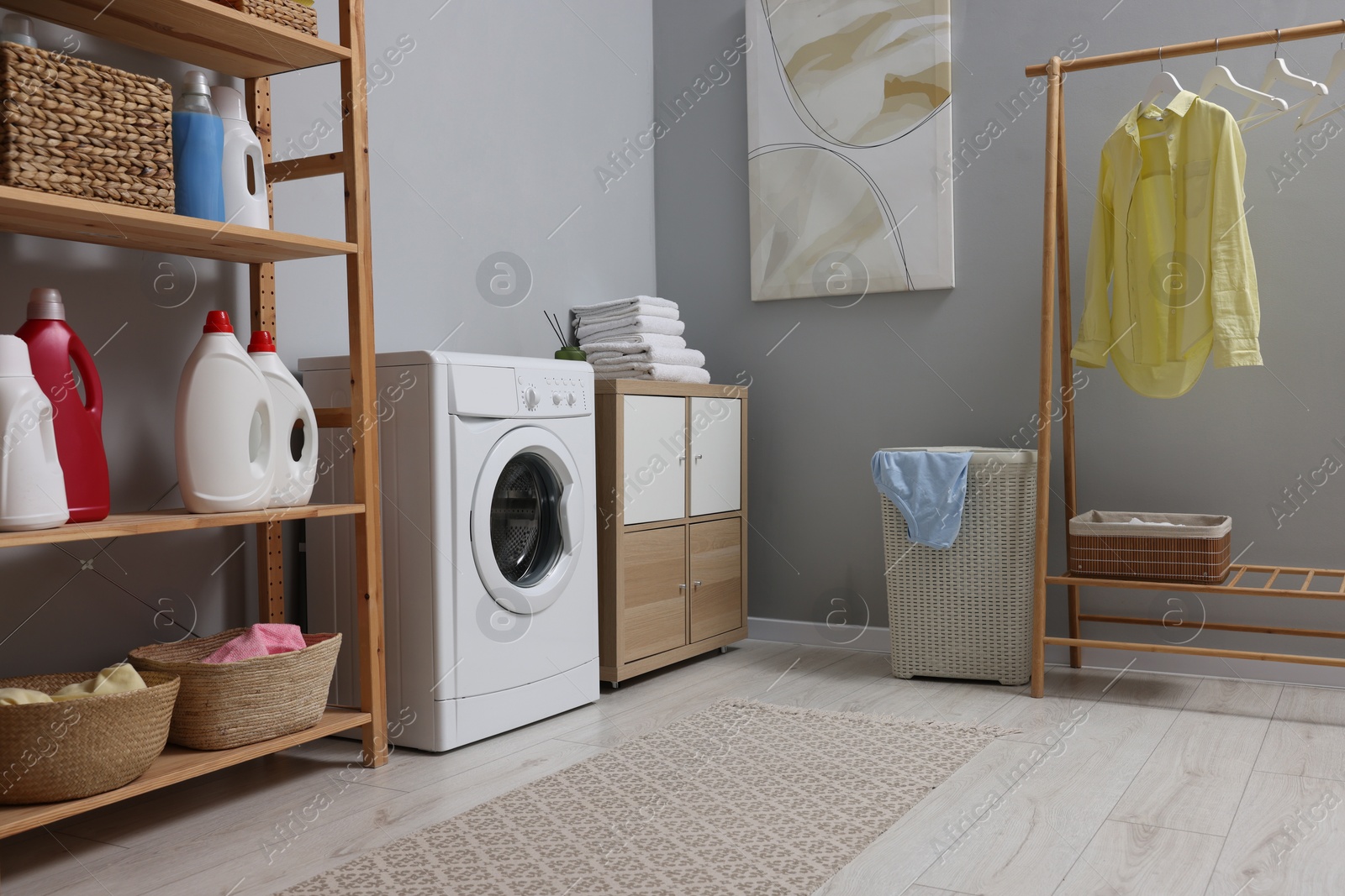 Photo of Laundry room interior with washing machine and furniture