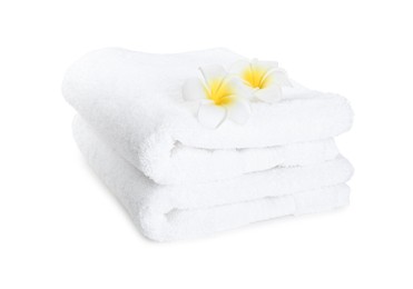 Photo of Terry towels and plumeria flowers isolated on white