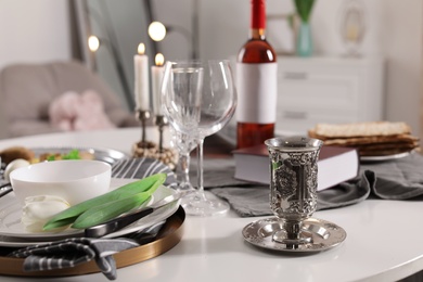 Photo of Festive Passover table setting at home. Pesach celebration