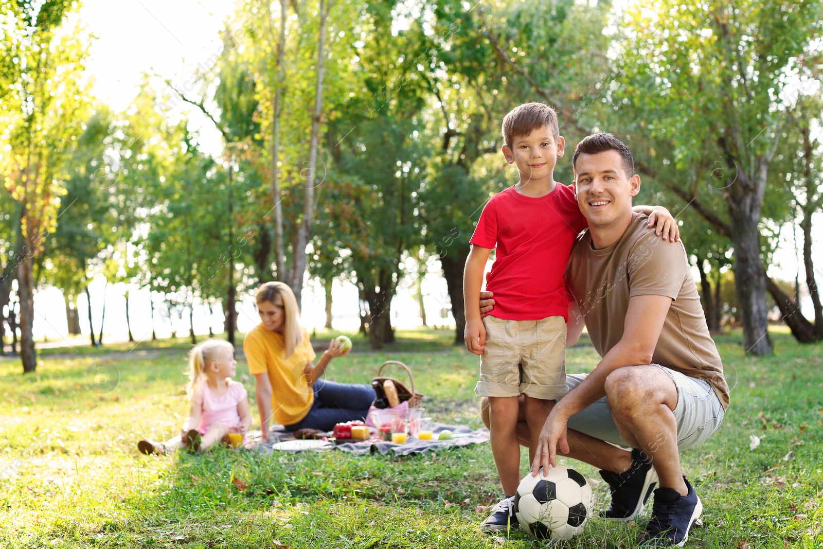 Photo of Happy family having picnic in park on sunny day