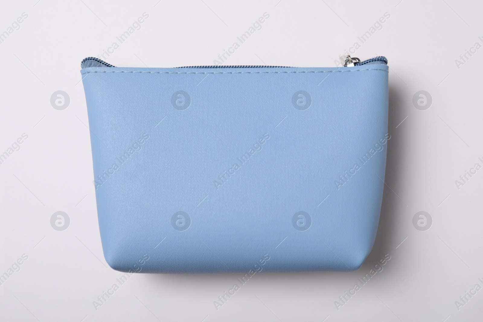 Photo of Light blue cosmetic bag isolated on white, top view