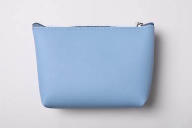 Light blue cosmetic bag isolated on white, top view