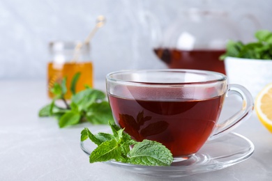 Fresh tea with mint on light table