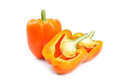 Photo of Whole and cut orange bell peppers on white background