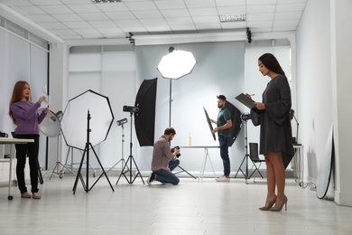 Photo studio with professional equipment and team of workers