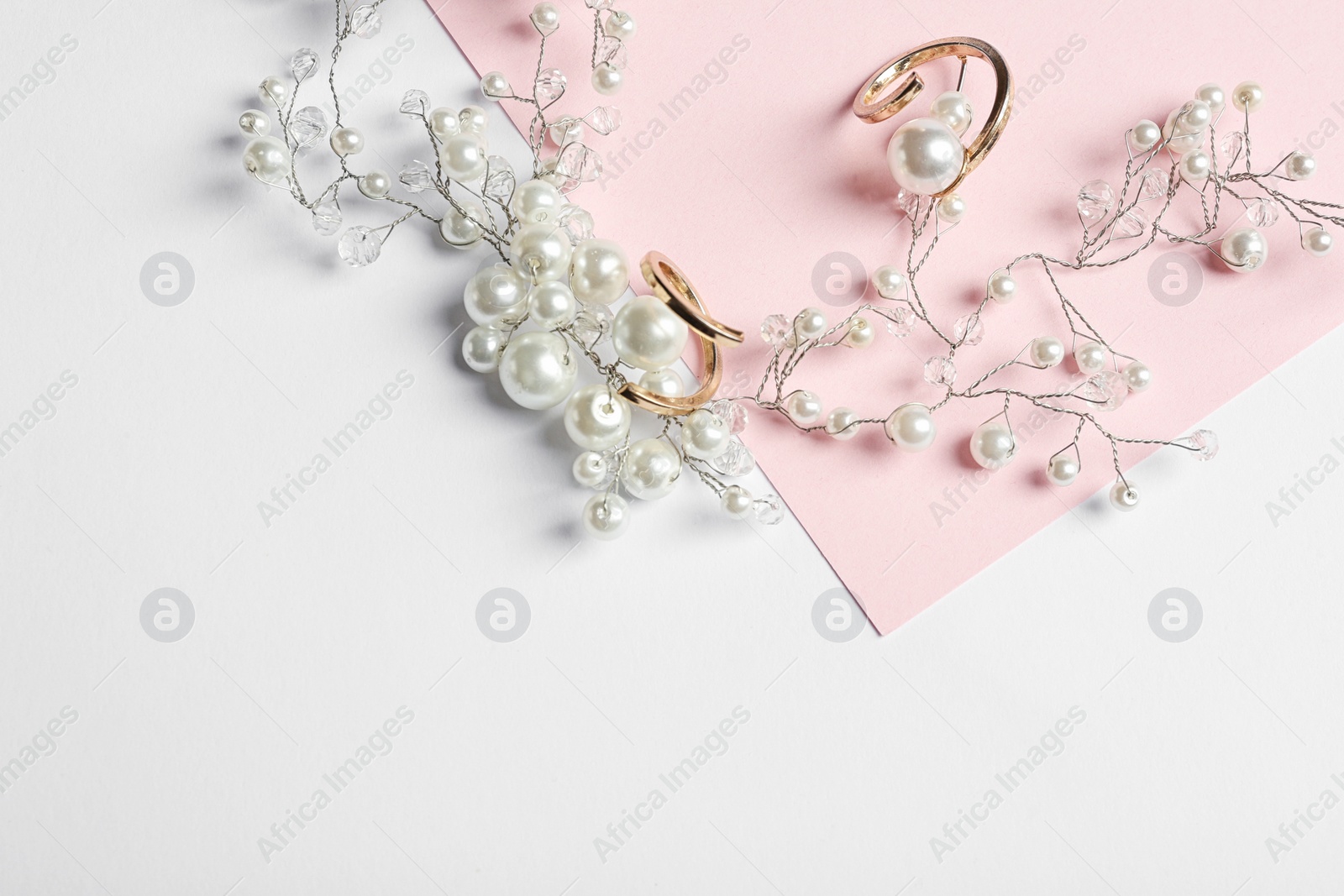 Photo of Elegant jewelry on color background, above view with space for text