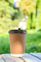 Photo of Paper cup on street outdoors. Takeaway drink