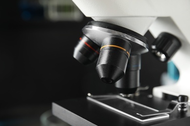 Photo of Modern microscope with different lenses in laboratory, closeup. Medical equipment