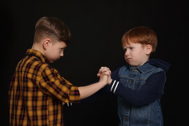 Two boys fighting on white background. Children's bullying