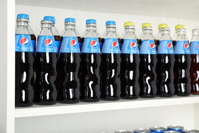 Photo of MYKOLAIV, UKRAINE - FEBRUARY 10, 2021: Bottles of Pepsi on white shelf