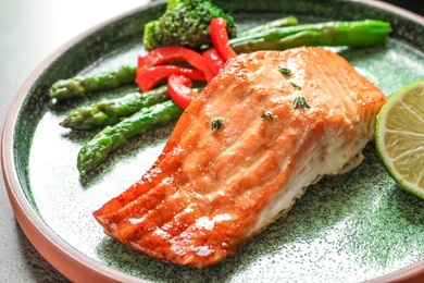 Plate with tasty freshly cooked salmon, closeup