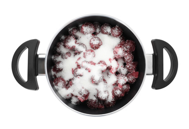 Photo of Pot with cherries and sugar on white background, top view. Making delicious jam