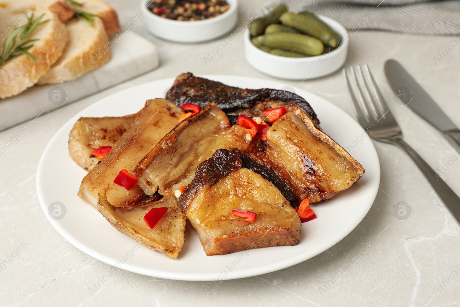 Photo of Tasty fried pork lard with pepper on light table