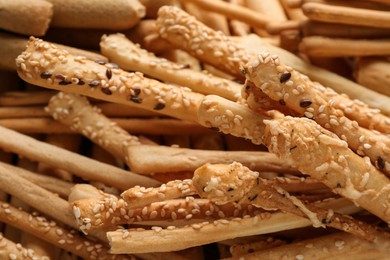 Photo of Delicious grissini sticks as background, closeup view