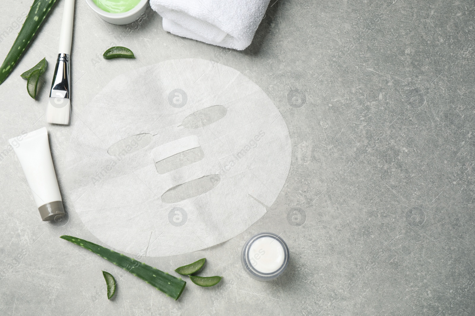 Photo of Flat lay composition with different cosmetic products and aloe on grey table, space for text