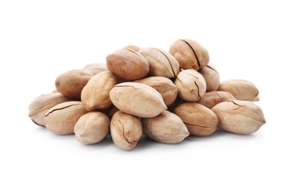 Photo of Heap of pecan nuts in shell on white background