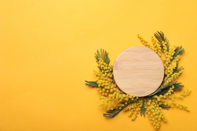 Photo of Beautiful floral composition with mimosa flowers on yellow background, flat lay. Space for text