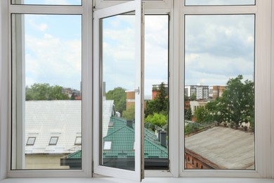 Photo of Open window with white plastic frame indoors