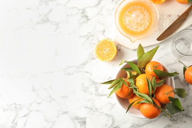 Photo of Flat lay composition with ripe tangerines and juicer on marble background. Space for text