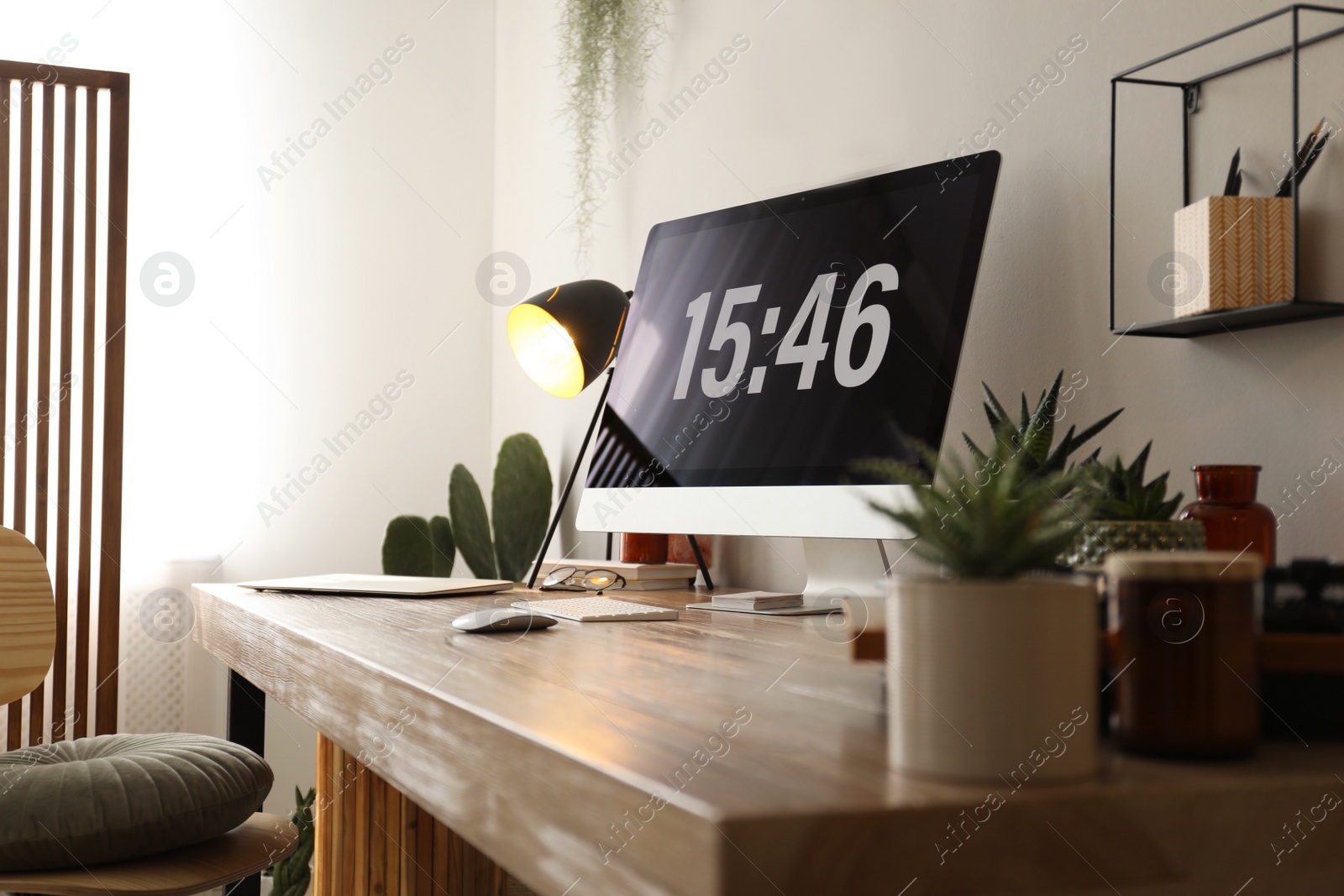 Photo of Modern computer and laptop on wooden desk in room. Interior design