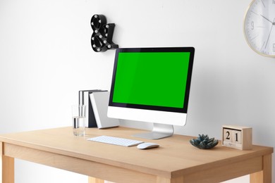 Image of Computer display with chroma key on desk in room. Comfortable workplace