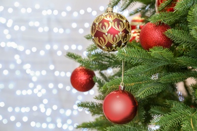 Christmas tree with festive decor against blurred fairy lights