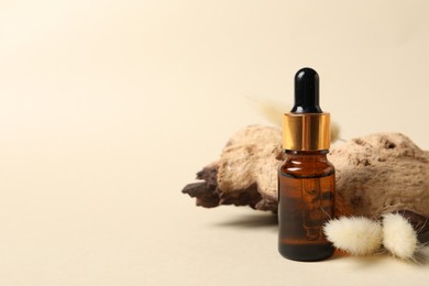 Photo of Composition with bottle of cosmetic serum on beige background. Space for text