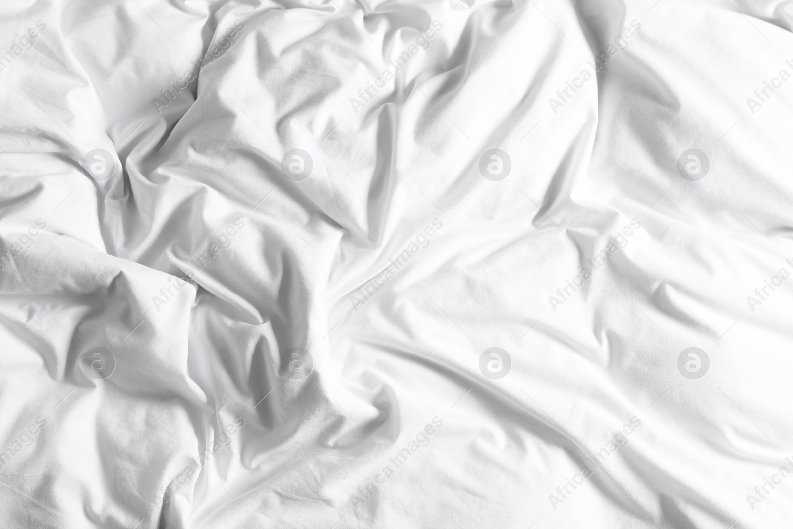 Photo of Crumpled white fabric as background, closeup view