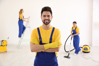 Professional janitor in uniform indoors. Cleaning service