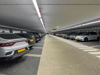 Many different cars in underground parking garage