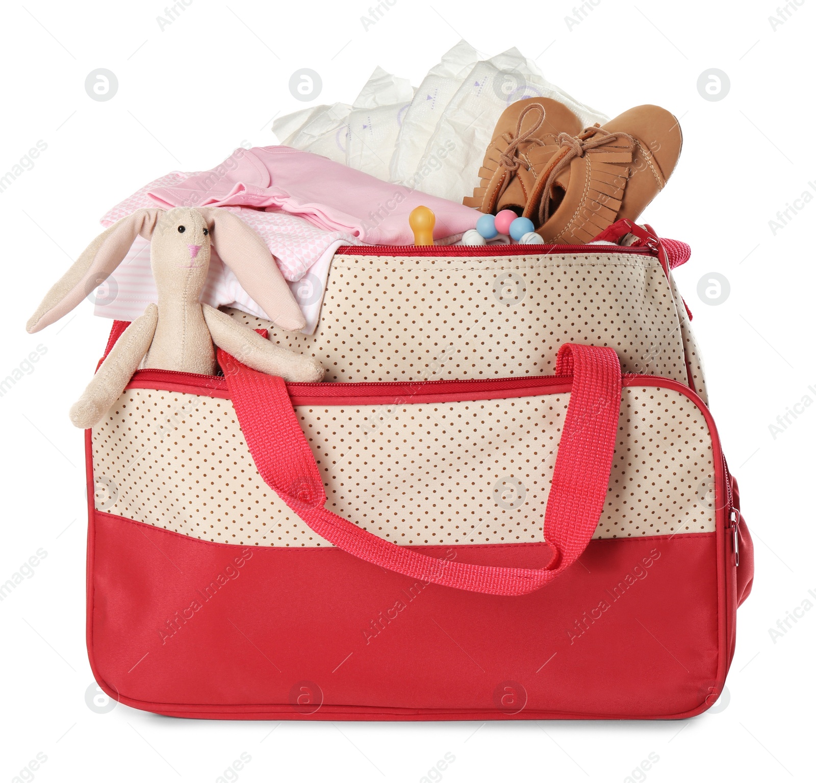 Photo of Maternity bag with child's clothes and accessories on white background