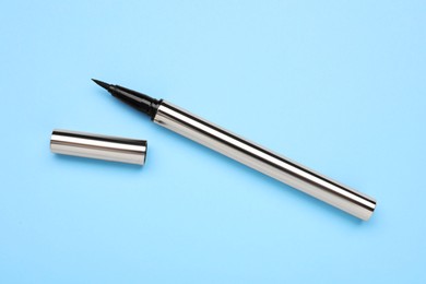 Photo of Eyeliner marker on light blue background, top view. Makeup product