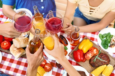 Photo of Friends with drinks at barbecue party outdoors, above view
