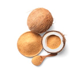 Photo of Coconut sugar in bowl, spoon and fruits isolated on white, top view