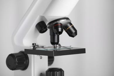 Modern microscope on light background, closeup. Medical equipment