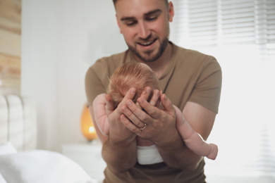 Father with his newborn son at home