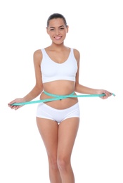 Photo of Slim woman measuring her waist on white background. Weight loss