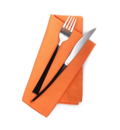 Photo of Orange napkin with fork and knife on white background, top view