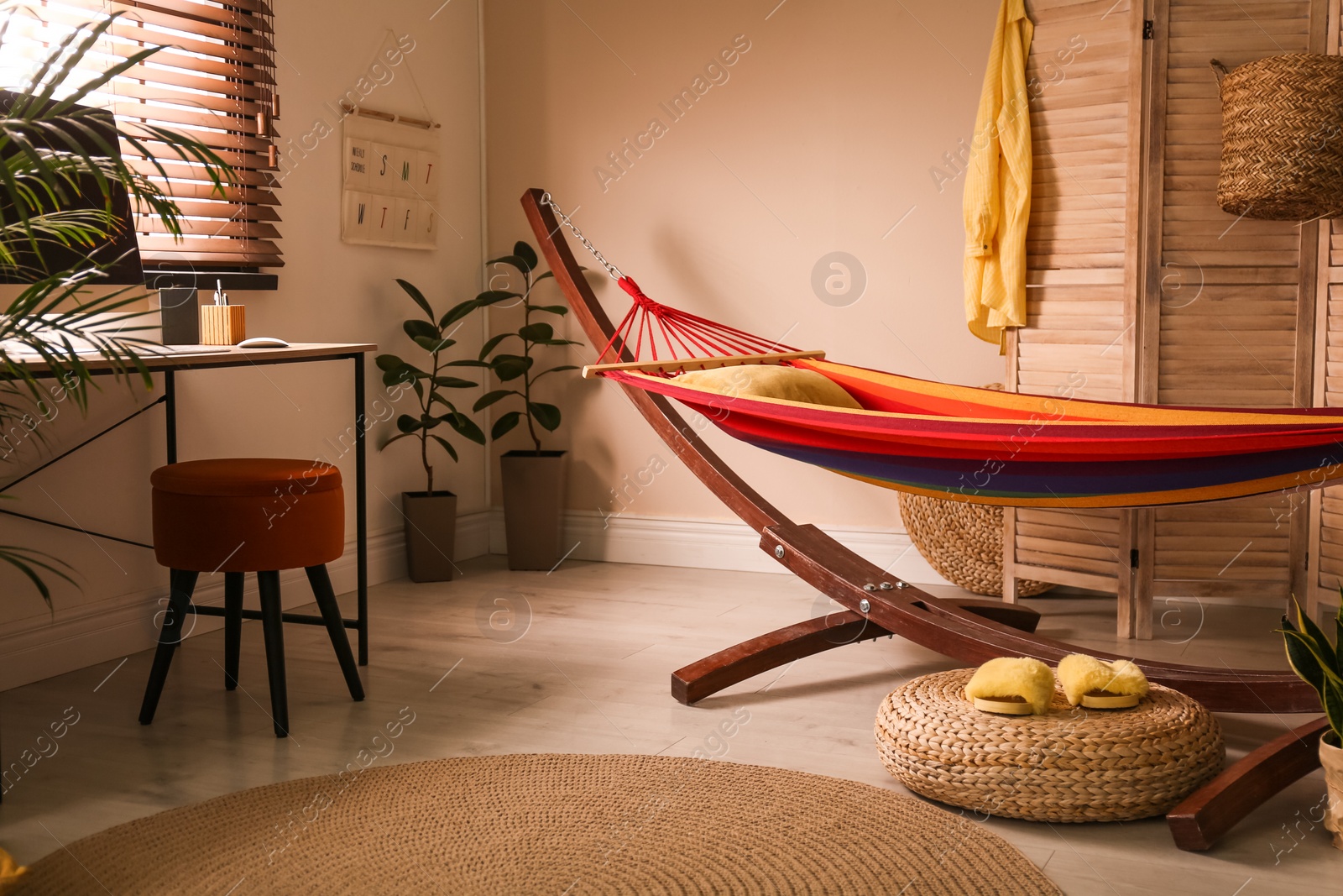 Photo of Colorful hammock with pillow in modern room interior