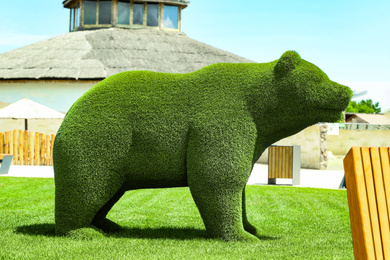 Photo of Beautiful bear shaped topiary at zoo on sunny day. Landscape gardening