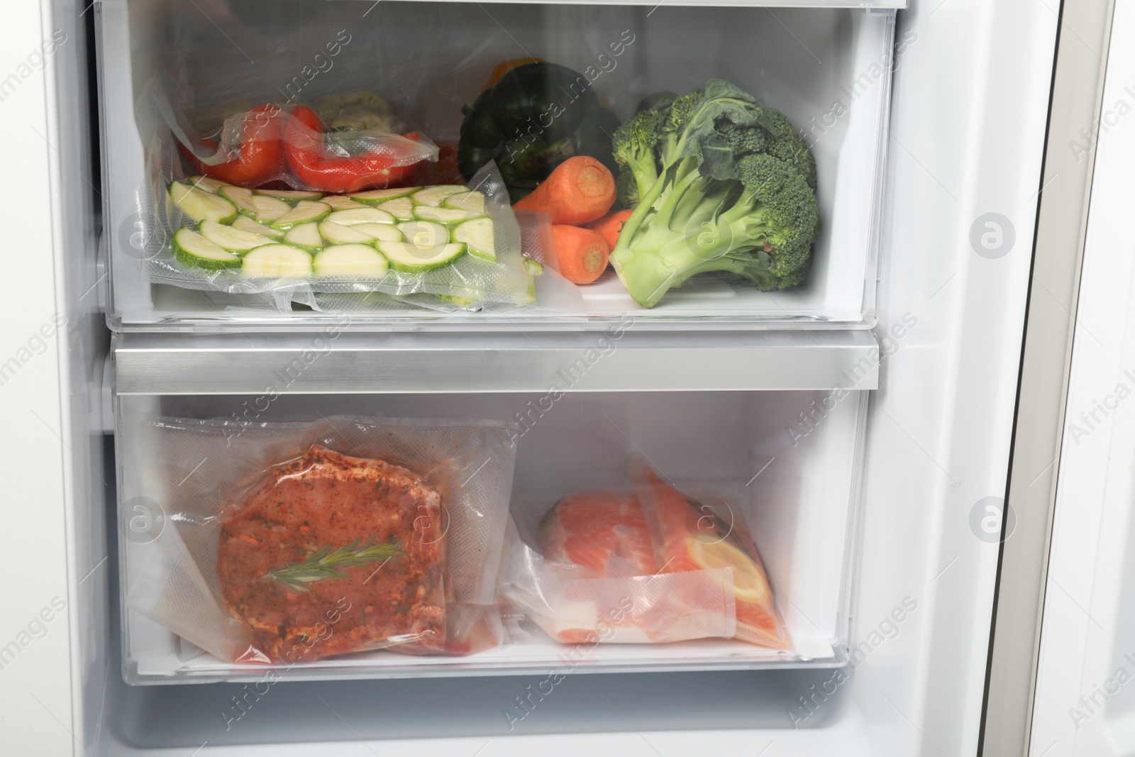 Photo of Vacuum bags with different products in fridge. Food storage