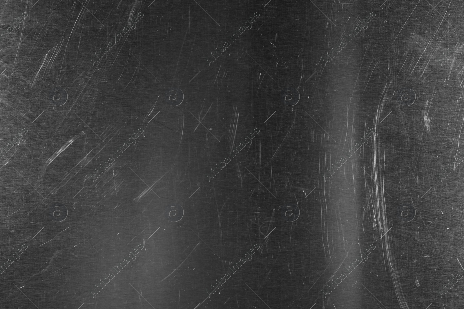 Photo of Old metal surface with scratches as background, closeup
