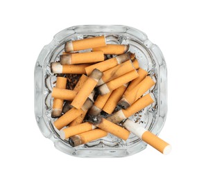 Photo of Glass ashtray full of cigarette stubs isolated on white, top view