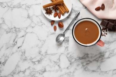 Flat lay composition with yummy hot chocolate on white marble table. Space for text