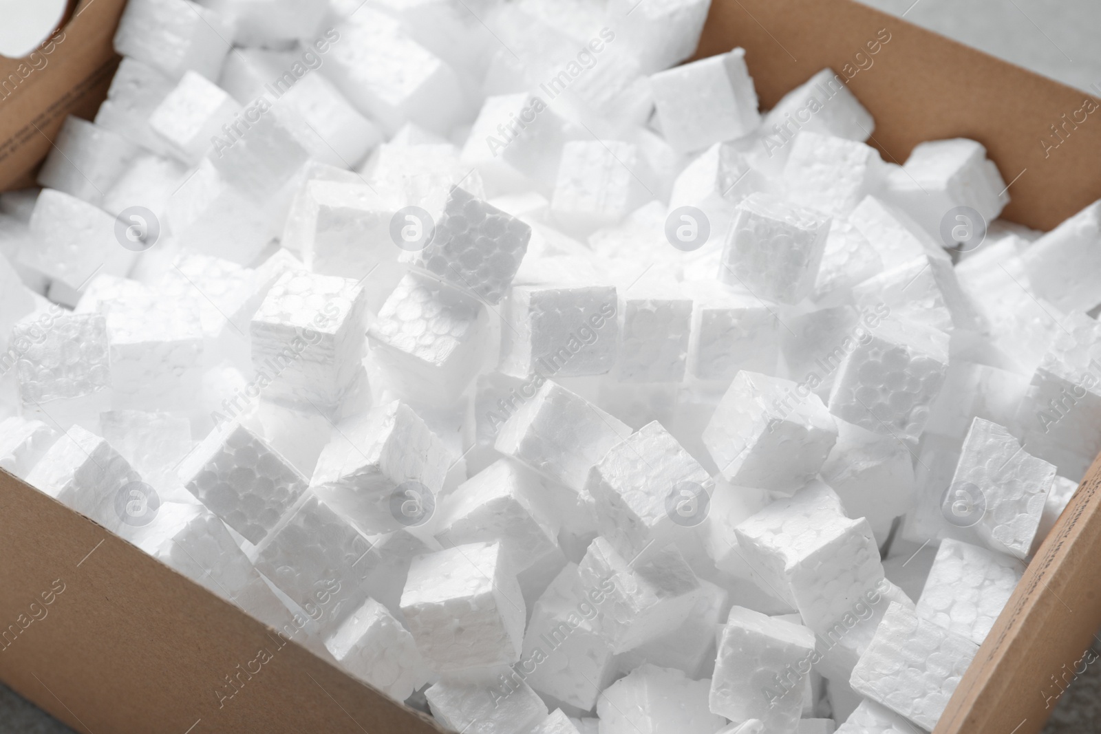 Photo of Closeup view of cardboard box with styrofoam cubes