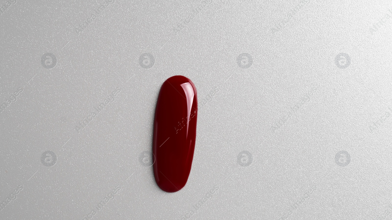 Photo of Drop of blood on grey background, top view