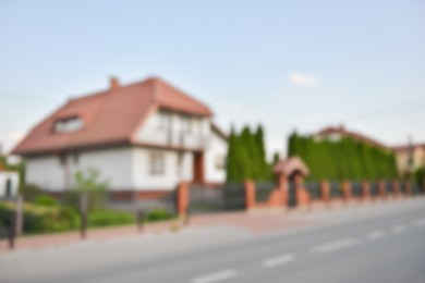 Blurred view of suburban street with beautiful house